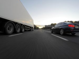 A truck and a car on a highway