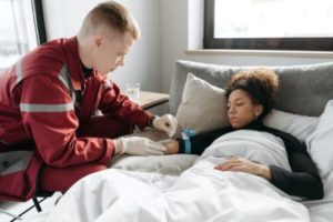 woman receiving medical care in the bed