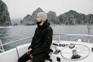 A man in a hat, sitting on a boat