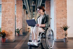 Woman in a wheelchair working on a laptop