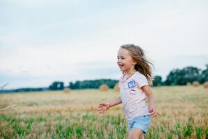 Young girl running through a field