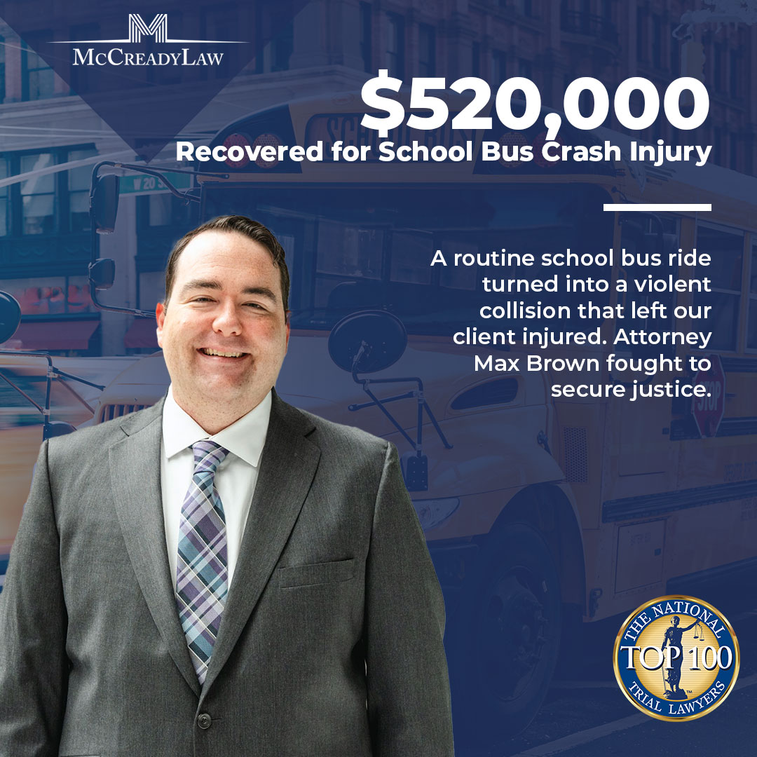Max Brown in a gray suit smiles in front of a school bus, with text about a $520,000 recovery for a crash injury.